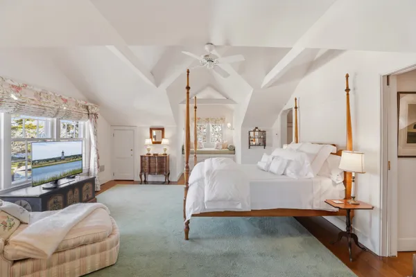 a spacious bedroom with a bed and a couch