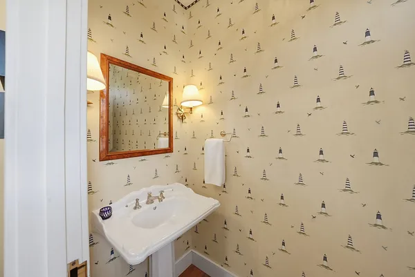 a bathroom with a sink a mirror and a shower