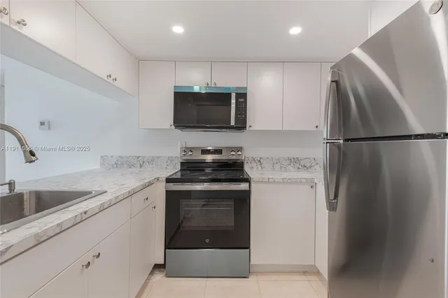 a kitchen with a refrigerator sink and microwave