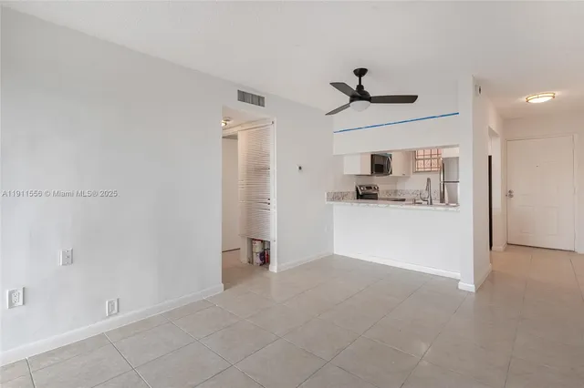 a view of a kitchen with a sink and cabinet area