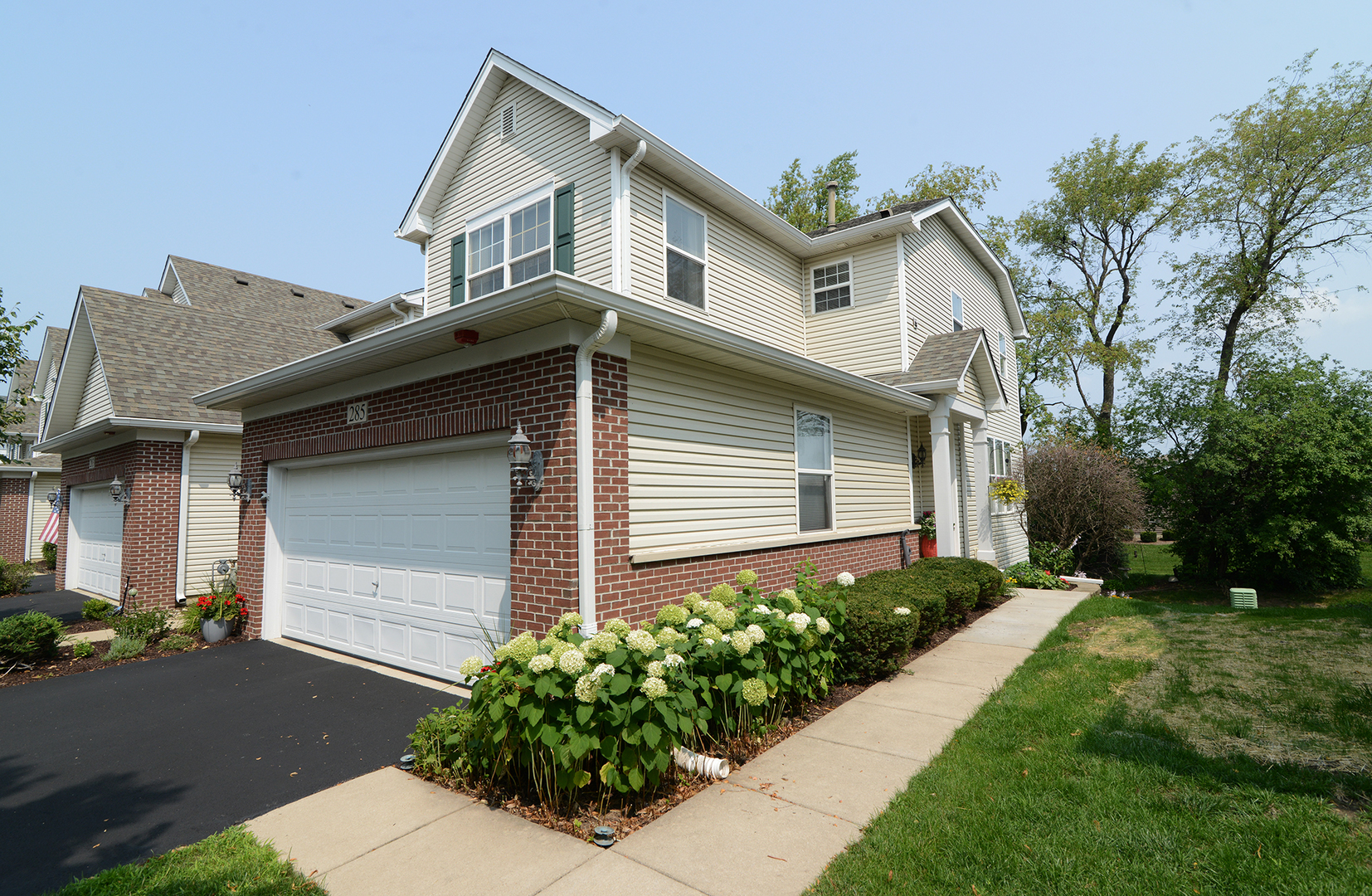 285 Ridge Road North Aurora, IL 60542 - Photo 2 of 24 a front view of a house with a yard and potted plants