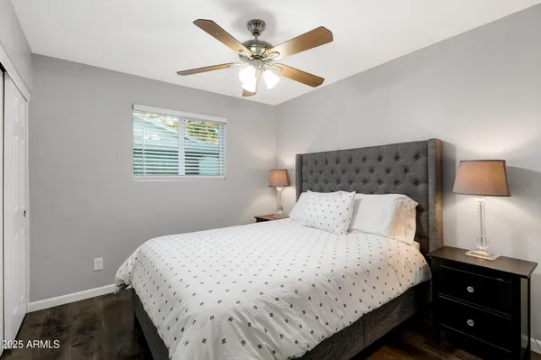 a bedroom with a bed and a night stand