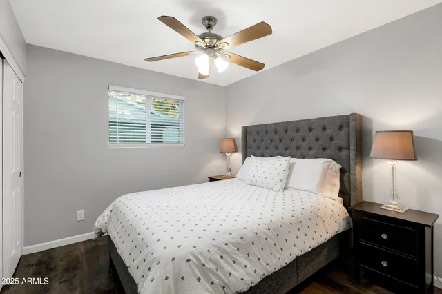 a bedroom with a bed and a night stand