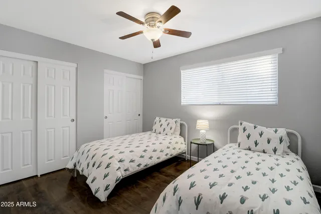 a bedroom with two beds and a chandelier