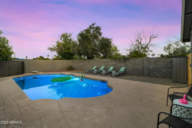 a view of swimming pool with outdoor seating and wooden floor