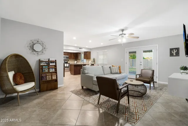 a living room with furniture and a large mirror
