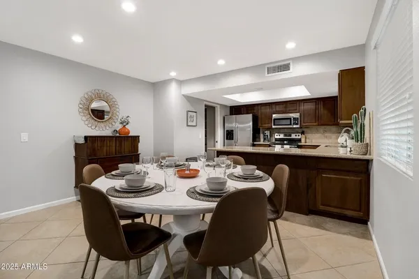 a kitchen with a table and chairs in it