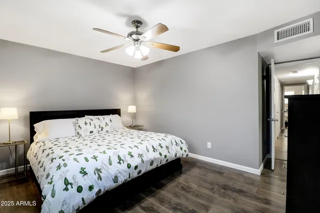 a bedroom with a large bed and a chandelier