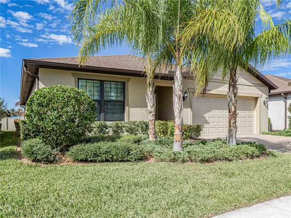 a view of kitchen with granite countertop kitchen island wooden floors white cabinets and stainless steel appliances