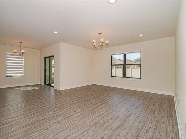 a kitchen with granite countertop white cabinets white stainless steel appliances a sink and a window