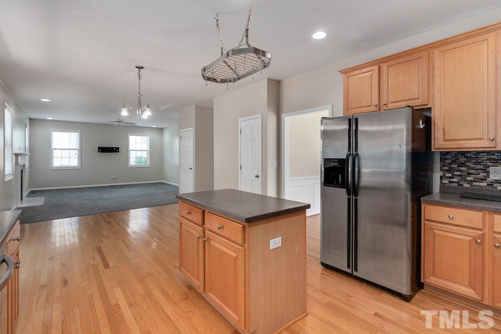 110 Castlebar Lane Durham, NC 27713 - Photo 11 of 32 a kitchen with stainless steel appliances granite countertop a refrigerator a sink dishwasher a stove and white countertops with wooden floor