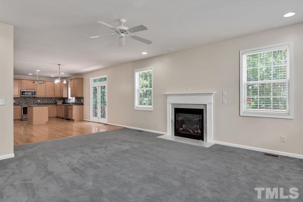 110 Castlebar Lane Durham, NC 27713 - Photo 12 of 32 a view of a kitchen an empty space and a fireplace