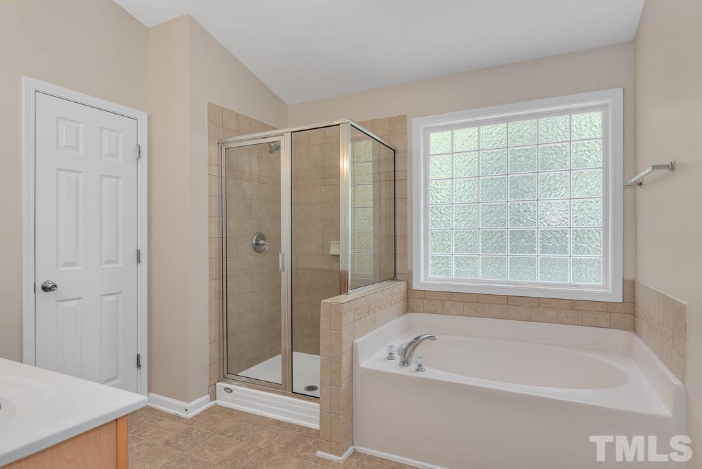 110 Castlebar Lane Durham, NC 27713 - Photo 21 of 32 a bath room with a bath tub and a shower