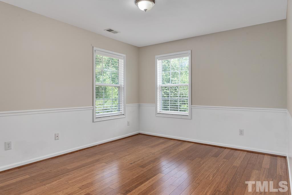 110 Castlebar Lane Durham, NC 27713 - Photo 22 of 32 a view of an empty room with wooden floor and a window