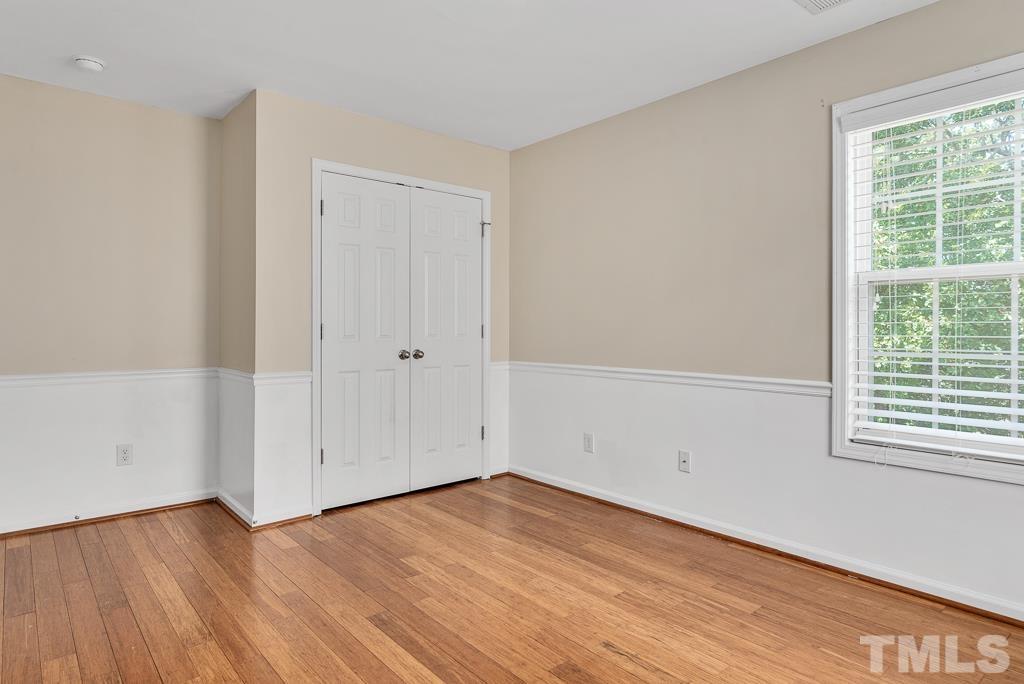 110 Castlebar Lane Durham, NC 27713 - Photo 23 of 32 a view of an empty room with wooden floor and a window