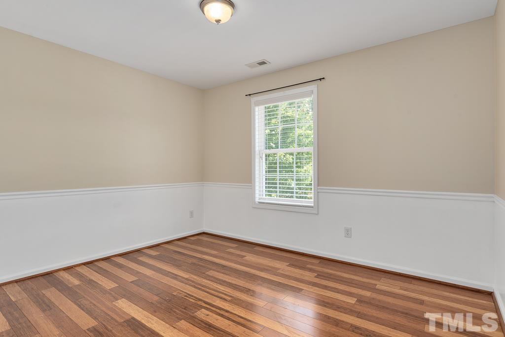 110 Castlebar Lane Durham, NC 27713 - Photo 26 of 32 an empty room with wooden floor and windows