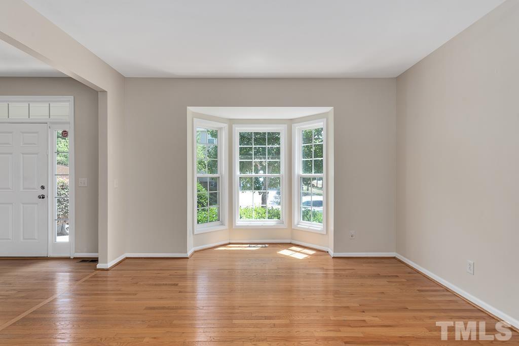 110 Castlebar Lane Durham, NC 27713 - Photo 5 of 32 a view of an empty room with wooden floor and a window