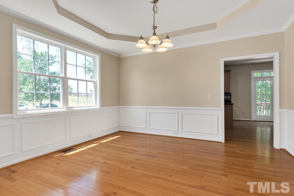 110 Castlebar Lane Durham, NC 27713 - Photo 6 of 32 a view of empty room with wooden floor and fan