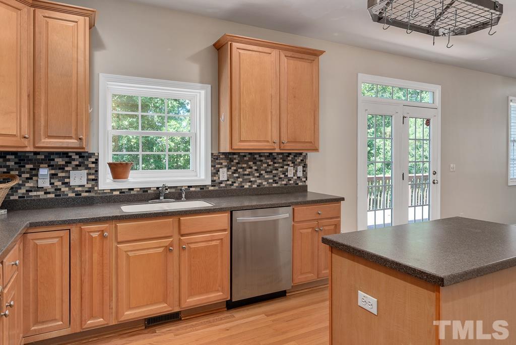 110 Castlebar Lane Durham, NC 27713 - Photo 9 of 32 a kitchen with granite countertop a sink cabinets and window