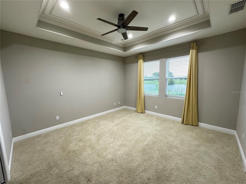 3302 Sagebrush Street Harmony, FL 34773 - Photo 15 of 19 en empty room with windows and ceiling fan
