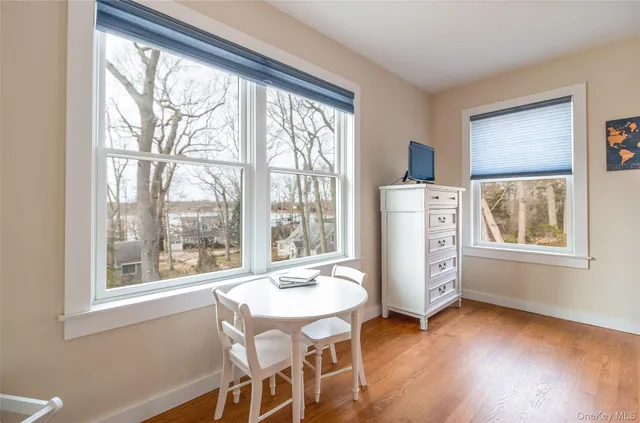 a living room with a bed furniture and a large window