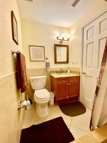 a bathroom with a toilet a sink and a mirror