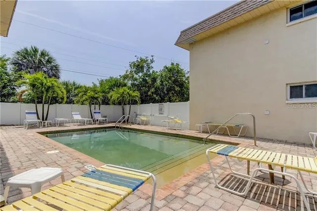 a view of a swimming pool with a lounge chair