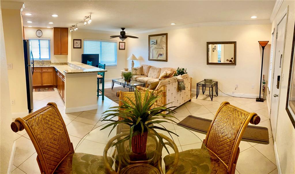 9060 Blind Pass Road, Unit 25 St. Pete Beach, FL 33706 - Photo 3 of 25 a view of a dining room with furniture