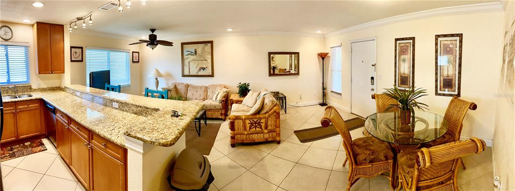 9060 Blind Pass Road, Unit 25 St. Pete Beach, FL 33706 - Photo 6 of 25 a living room with furniture and wooden floor