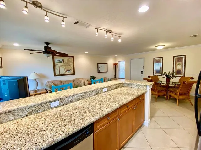 a living room with kitchen island furniture and a wooden floor