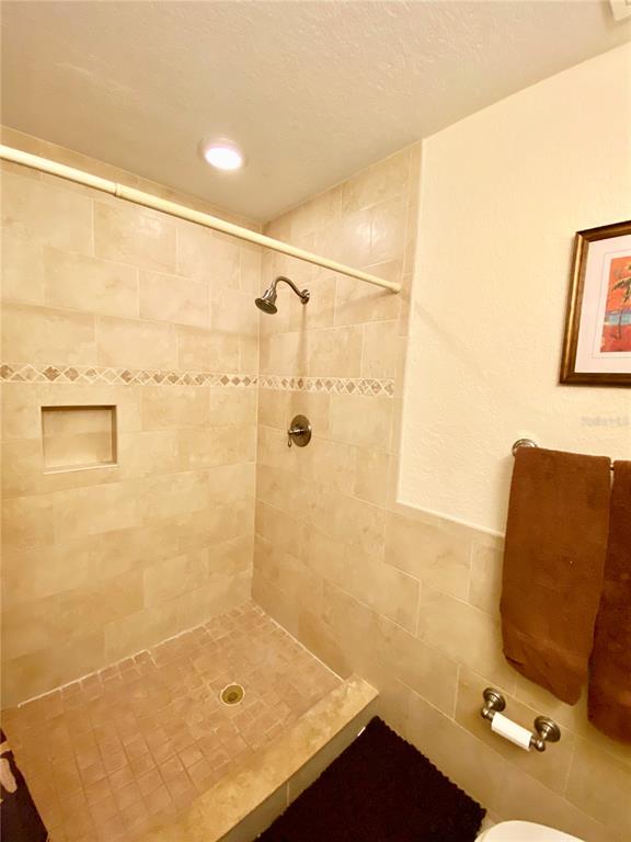 9060 Blind Pass Road, Unit 25 St. Pete Beach, FL 33706 - Photo 10 of 25 a bathroom with a sink and a shower