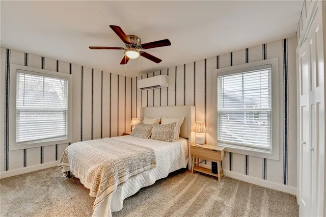 a bedroom with a large bed and a window