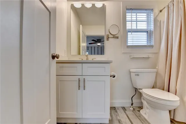 a bathroom with a toilet a sink and a mirror