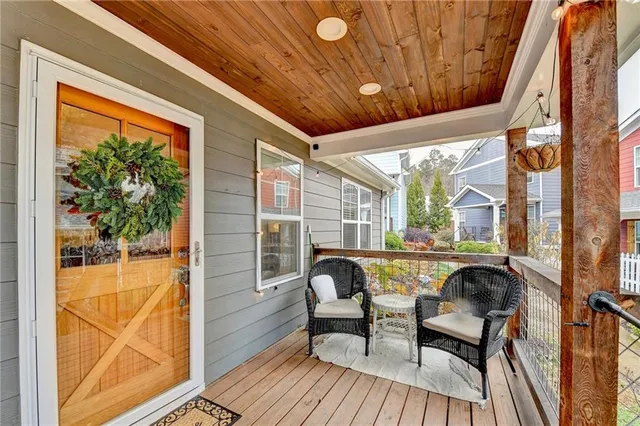 a balcony with couple of chairs and couch