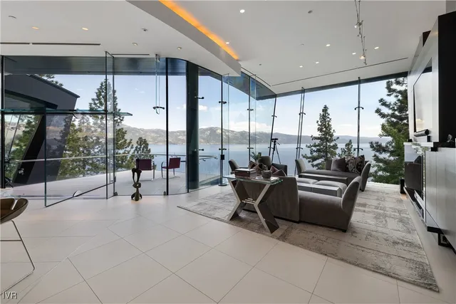 a view of a dining room with furniture water view and large windows