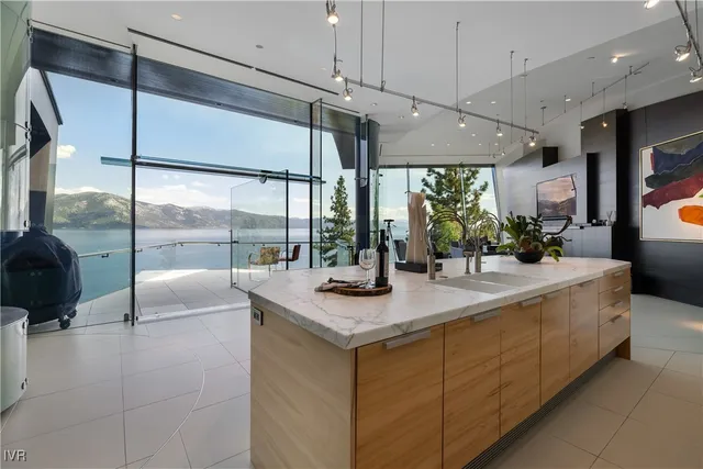 a kitchen with kitchen island a large window in it