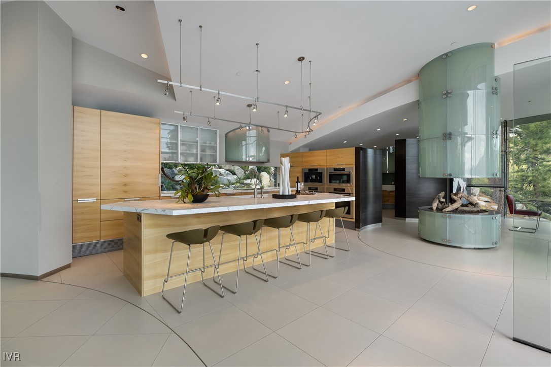 580 Gonowabie Road Crystal Bay, NV 89402 - Photo 15 of 50 a kitchen with stainless steel appliances kitchen island granite countertop a table and chairs in it