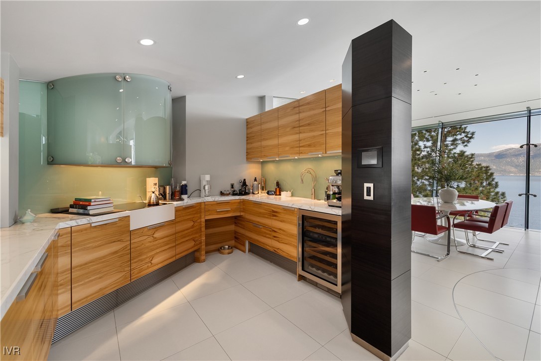 580 Gonowabie Road Crystal Bay, NV 89402 - Photo 18 of 50 a large kitchen with stainless steel appliances kitchen island granite countertop a refrigerator and a sink