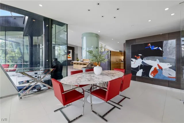 a living room with furniture a flat screen tv and floor to ceiling window
