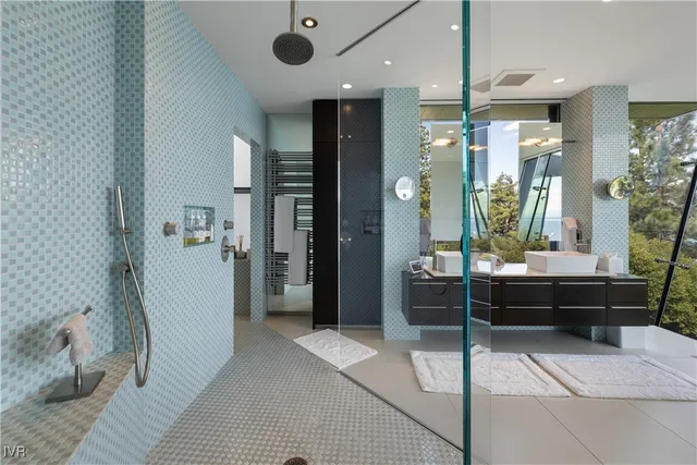 a bathroom with a double vanity sink toilet and shower