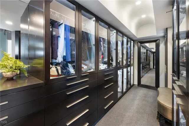 a view of a hallway with mirror and furniture