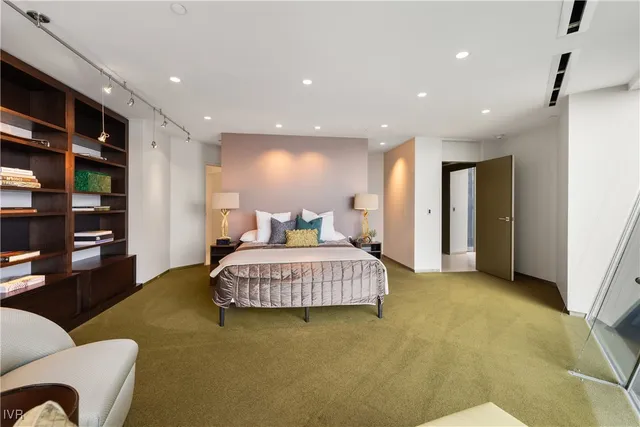 a spacious bedroom with a bed and furniture