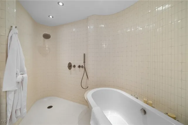 a bathroom with a bathtub and shower