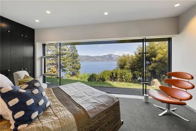 a bedroom with a bed chair and window