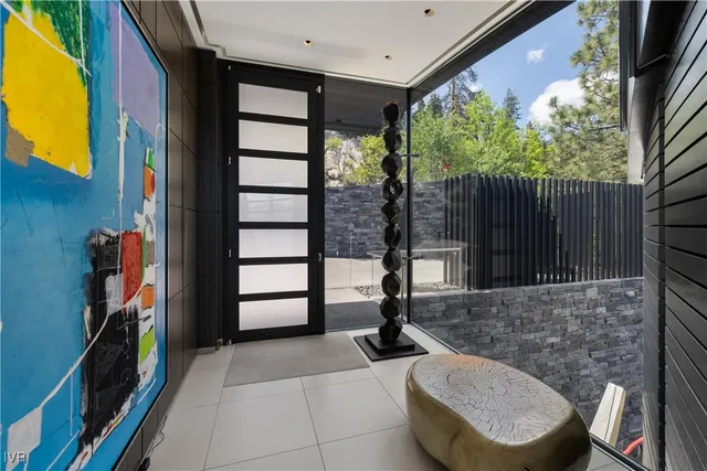 a view of a porch with furniture and floor to ceiling window