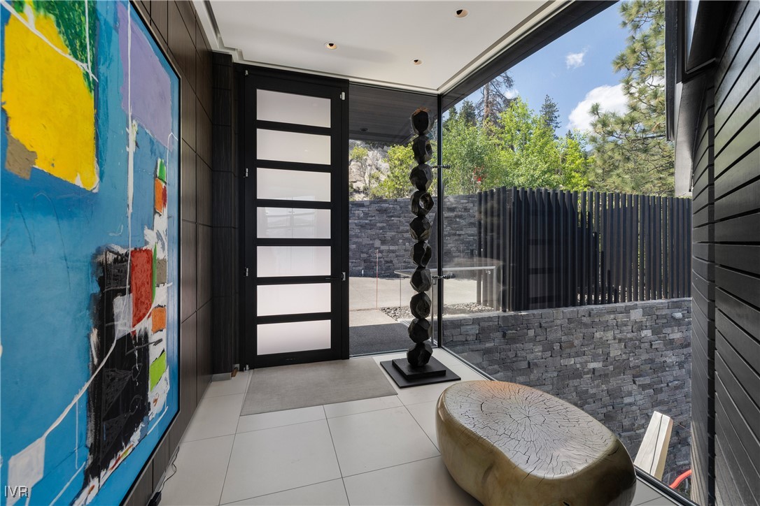 580 Gonowabie Road Crystal Bay, NV 89402 - Photo 9 of 50 a view of a porch with furniture and floor to ceiling window