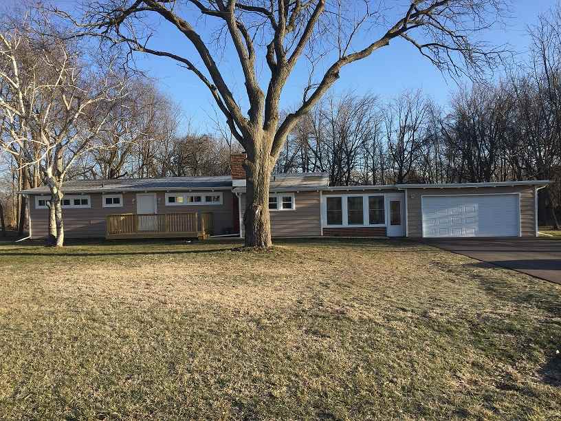 4985 Freeport Road Rockton, IL 61072 - Photo 1 of 24 a front view of a house with a garden