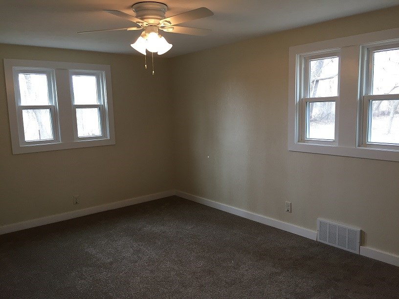 4985 Freeport Road Rockton, IL 61072 - Photo 20 of 24 an empty room with windows and chandelier fan