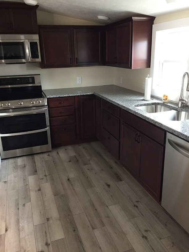 4985 Freeport Road Rockton, IL 61072 - Photo 24 of 24 a kitchen with wooden cabinets and a sink