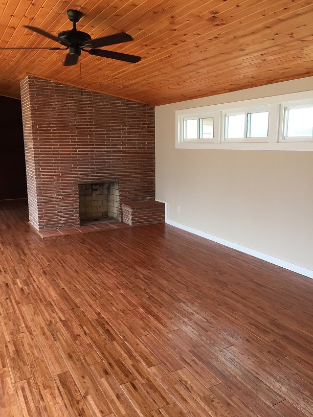 4985 Freeport Road Rockton, IL 61072 - Photo 5 of 24 an empty room with wooden floor a fireplace and windows